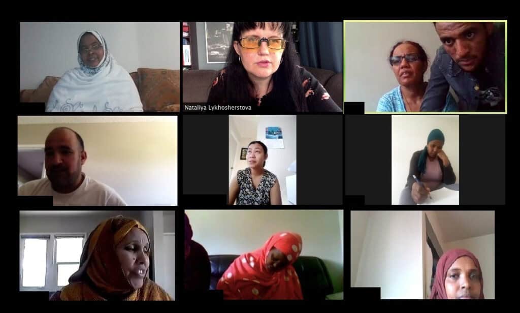 A screenshot of a video call showing ten people in separate frames, engaged in conversation. Most appear to be sitting indoors, some with headscarves, and a variety of expressions are visible.